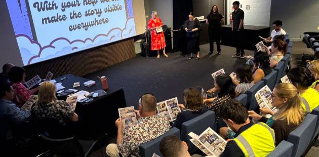 A group of presenters speaking to an audience of people.