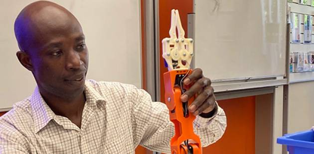 Dr David Ompong with the robot arm