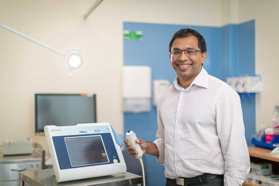 Man standing beside medical equipment