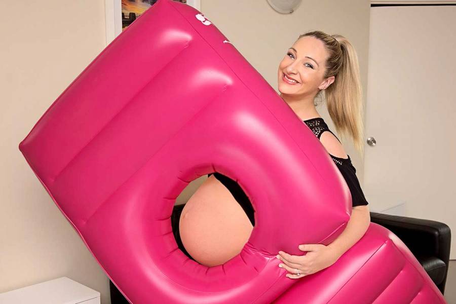 Amy Page holding her inflatable bed for pregnant women