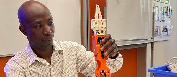 Dr David Ompong with the robot arm