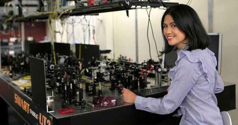 Young lady in front of a bench of equipment