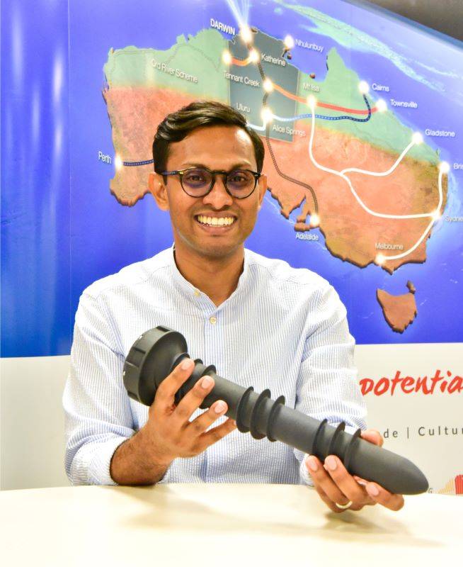 Project manager Kamal Ali holds a smart water sensor